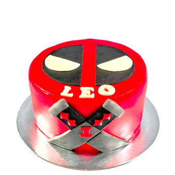 Deadpool dog birthday cake featuring red design with iconic mask and name LEO on top.
