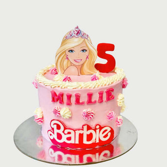 Barbie themed dog birthday cake featuring a pink design with 'Millie' and a sparkling crown.
