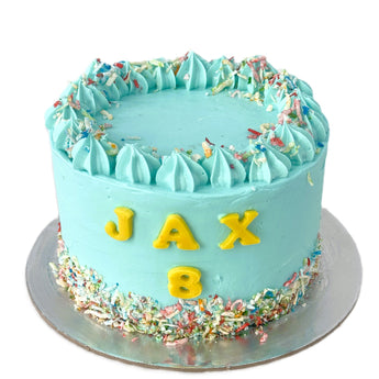 Dog Birthday Cake with Sprinkles for Jax's 8th Dog Party, featuring vibrant icing and colorful sprinkles.