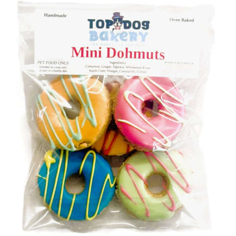 Mini dog birthday treats in colorful donut shapes, perfect for a dog's party or special occasion.
