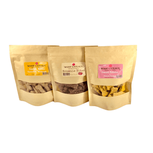 Homemade dog bone biscuits in three flavors: Peanut Butter, Brownie Bites, and Sweet Potato for healthy dog treats.
