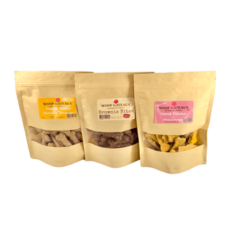 Homemade dog bone biscuits in three flavors: Peanut Butter, Brownie Bites, and Sweet Potato for healthy dog treats.