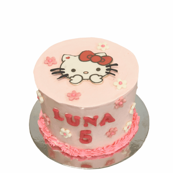 Hello Kitty dog birthday cake decorated with pink frosting and flowers celebrating Luna's 5th birthday.