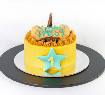 5 inch dog birthday cake decorated with icing and treats for a pup's special day.