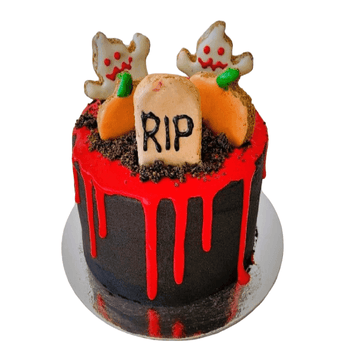 Halloween dog birthday cake with spooky decorations for a fun Dog Party, featuring ghosts and a tombstone.