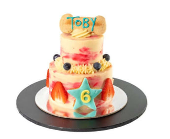 Personalized dog birthday cake featuring a 2-tier strawberry swirl design for Toby's 6th birthday dog party.