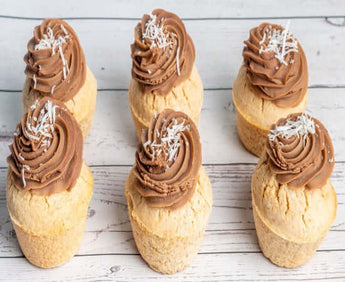 Dog-friendly pupcakes topped with chocolate frosting and coconut sprinkles for a tasty Dog Birthday Cake.
