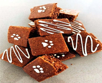 Delicious carob dog brownies with paw print design and Tapioca Icing, ideal for a Dog Party.