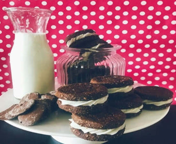 OREO dog biscuits arranged on a plate with a glass of milk and a jar, perfect for dog celebrations.