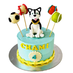 A 5-inch dog birthday cake featuring a playful dog caricature and colorful ball decorations for a fun dog party.